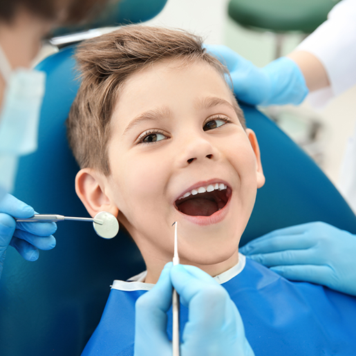 smiling child in a dentist chair